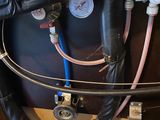 a black tank with a bunch of hoses attached to it