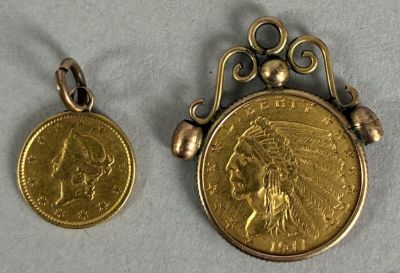 two gold coin pendants with indian head on them sitting next to each other