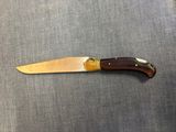 a close up of a knife sitting on top of a table