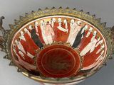 an image of a red and white bowl sitting on top of a table