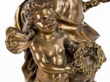 an antique bronze figurine of a child holding a flower