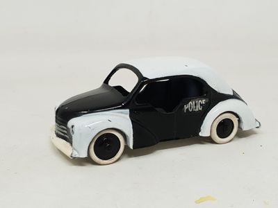 a black and white toy car on a white surface