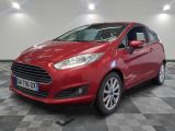 a red ford fiesta parked in a garage with a checkered floor