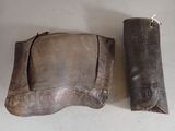 two pieces of leather and a leather case on a table