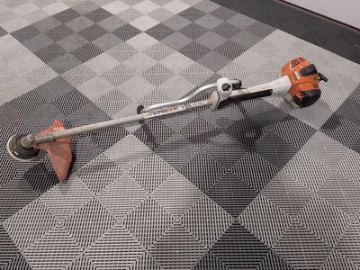 a man using a string trimmer to trim a floor
