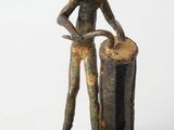 statue of a man holding a drum and a barrel