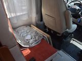 an image of the inside of a camper with aluminum foil on the seat