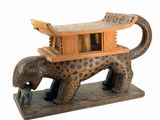 statue of an elephant with a house on its back