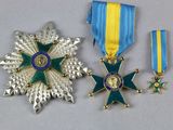 two medals and a star on a white surface