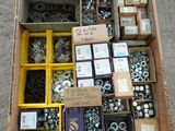 a box full of assorted bolts and nuts on the ground