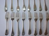 a lot of forks and spoons that are on the table