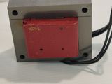 an image of a red and gray device on a white surface