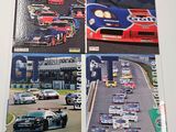 two books on a table with pictures of race cars on them