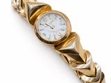 an image of a gold wrist watch with a chain around it