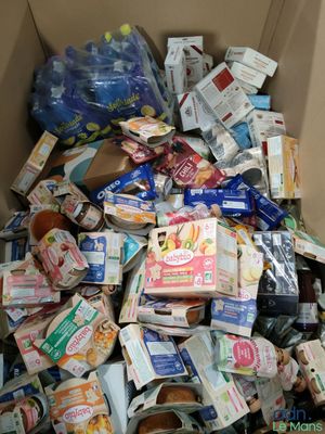 a cardboard box full of food and drinks in it
