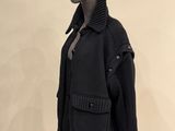 an image of a mannequin wearing a black jacket and skirt