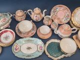 many different types of dishes and cups on the table