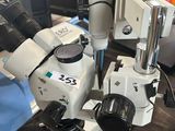 two microscopes are sitting on a table in a room