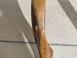 a close up of a wooden chair on a tile floor