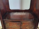 an old wooden chest with a mirror on top of it