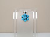 turquoise beaded earrings on a clear acrylic display case