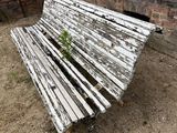 a wooden bench sitting in front of a brick wall