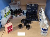 a counter top with a lot of bottles of water and other items on it
