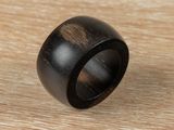 a close up of a wooden ring on a wooden surface
