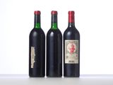 three bottles of wine are lined up on a table