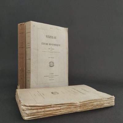 an old book sitting on top of a stack of books