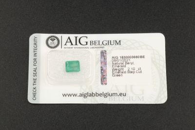 a close up of a piece of green emerald on a black surface