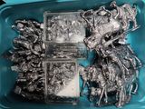 a blue container filled with silver metal figurines of knights