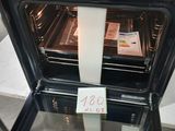 a black oven with a roll of toilet paper in it