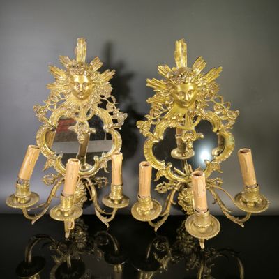 pair of gold plated wall sconces with flowers and candles