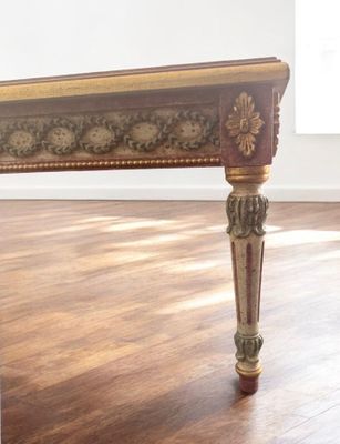 a wooden table with a floral design on the top of it