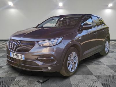 L'Opelge est garée dans une grande pièce au sol carrelé en damier.
