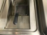 a deep fryer in the middle of the kitchen