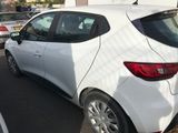 a white car parked in a parking lot next to other cars