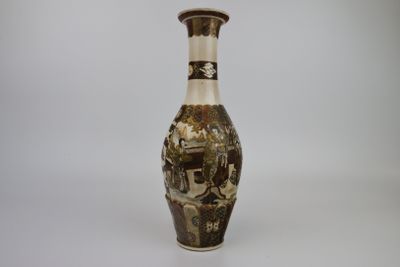 a brown and white vase sitting on a white surface