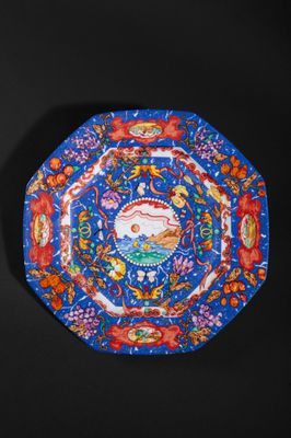 an image of a decorative plate with a fish and flowers on it
