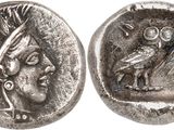 a silver coin with an image of a woman and a bird on it