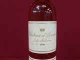 a bottle of wine sitting on top of a red table