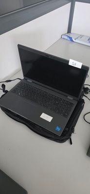 a laptop computer sitting on top of a desk next to a keyboard