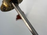 a close up view of a sword with a bird flying in the background
