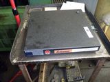 a laptop sitting on top of a table in a garage