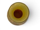 a yellow vase that has a brown substance in it