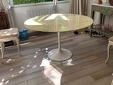 a dog standing in front of a table in a living room