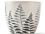 a black and white bowl with a plant design on it