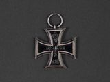 an iron cross pendant with a black and silver cross on it