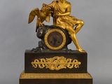 a statue of a man sitting on top of a clock